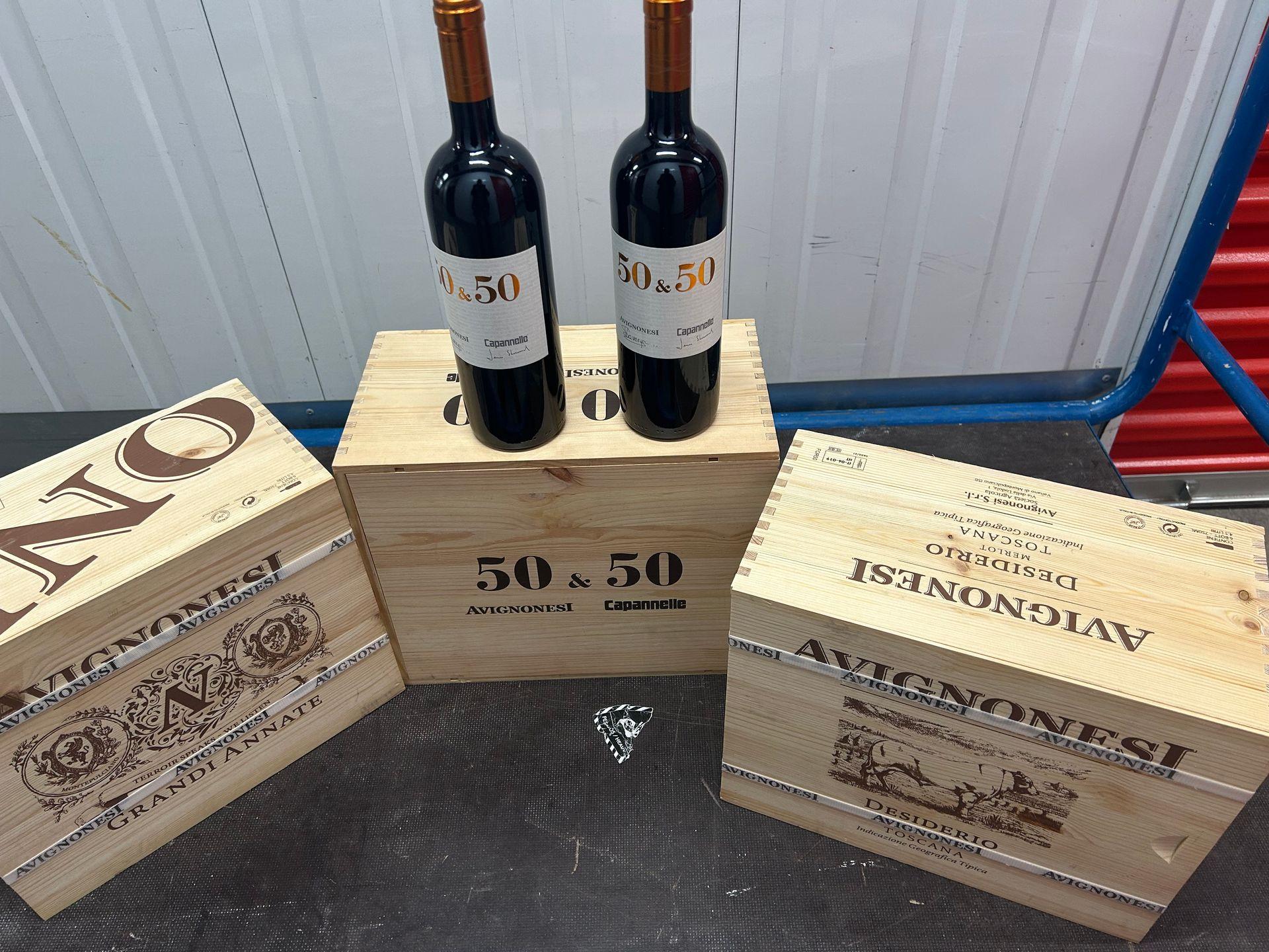 Two wine bottles on wooden crates with Avignonesi branding.